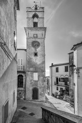 The ancient Clock Tower in the historic center of Manciano, Grosseto, Tuscany, Italy, in black and white