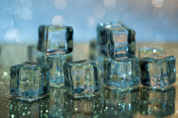 Melting ice cubes on glass table