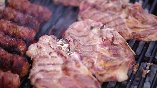 Meat grilling over the coals on barbeque
