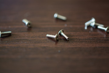 Small Screws on the Wooden Table.
