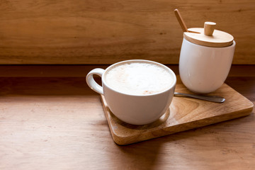 Hot art Latte Coffee in a cup on wooden table and Coffee shop.