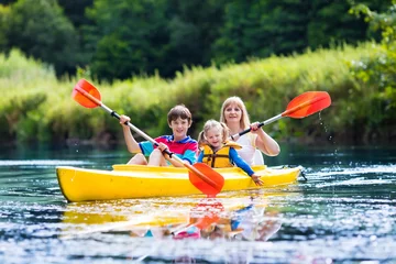 Foto op Canvas Family enjoying kayak ride on a river © famveldman