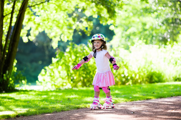 Little girl with roller skate shoes in a park