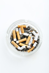 Cigarette butts with ash in ashtray isolated on a white