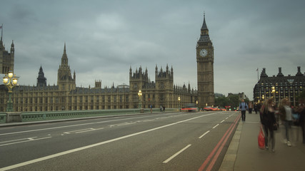 Obraz na płótnie Canvas LONDON, UK - APRIL: Traffic and pedestrians on Westminster Bridge near Big Ben and Parliament