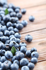 Ripe and tasty blueberries on brown wooden table