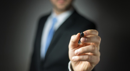 Businessman writing with a pen on a digital screen