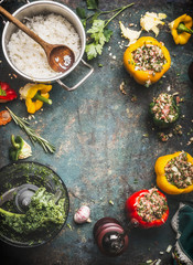 Stuffed paprika with minced meat, kale and rice on rustic kitchen table background, cooking preparation, top view, frame