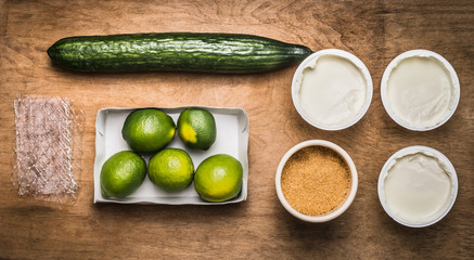 Ingredients for lime, cucumber  Yogurt  jelly  on wooden background, top view