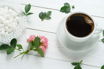 Coffee with marshmallows and a roses on a white wooden background. Flat lay. women's day, 8 march, 8 марта