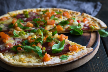 Pizza with salami and vegetables