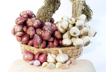 garlic, garlic cloves and onion in basket on white background.