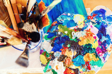 Sunny day artist workplace. Tools for creativity. Paint and canvas. creative atmosphere sunny studio Workshop