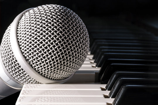 Microphone on piano keyboard, closeup