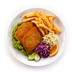 Fried pork chop, French fries and vegetables 