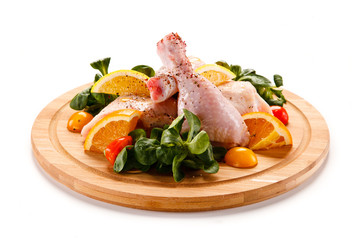 Grilled chicken legs with chips and vegetables 