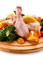 Grilled chicken legs with chips and vegetables 