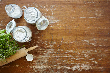 kitchen scene baking jars with flour wooden table