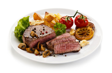 Steaks, baked potatoes and vegetable salad 