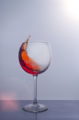 splash of red wine in a glass