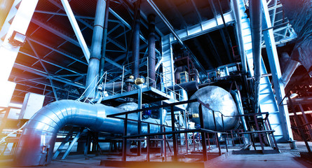 Equipment, cables and piping as found inside of a modern industrial power plant