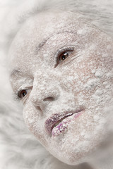 Obraz premium Portrait of a girl sprinkled with white flour