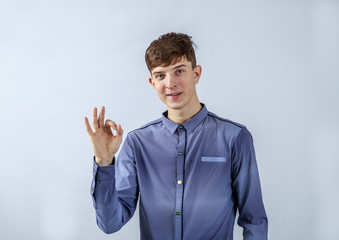 Cheerful guy in a shirt posing for the advertising