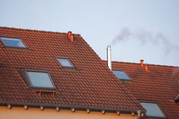 Obraz premium rauchende Schornsteine auf Hausdächern