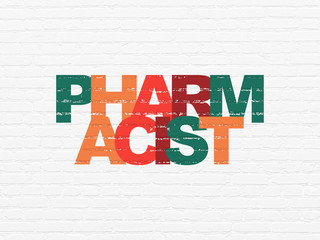 Medicine concept: Pharmacist on wall background