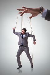 Businessman puppet being manipulated by boss