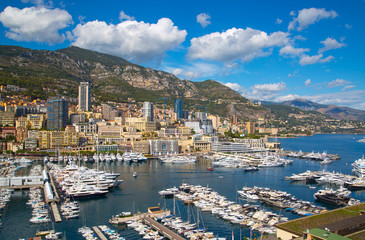 Fototapeta na wymiar Principality of Monaco. View of the seaport and the city of Monte Carlo with luxury yachts and sail boats 