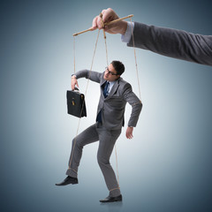 Businessman puppet being manipulated by boss