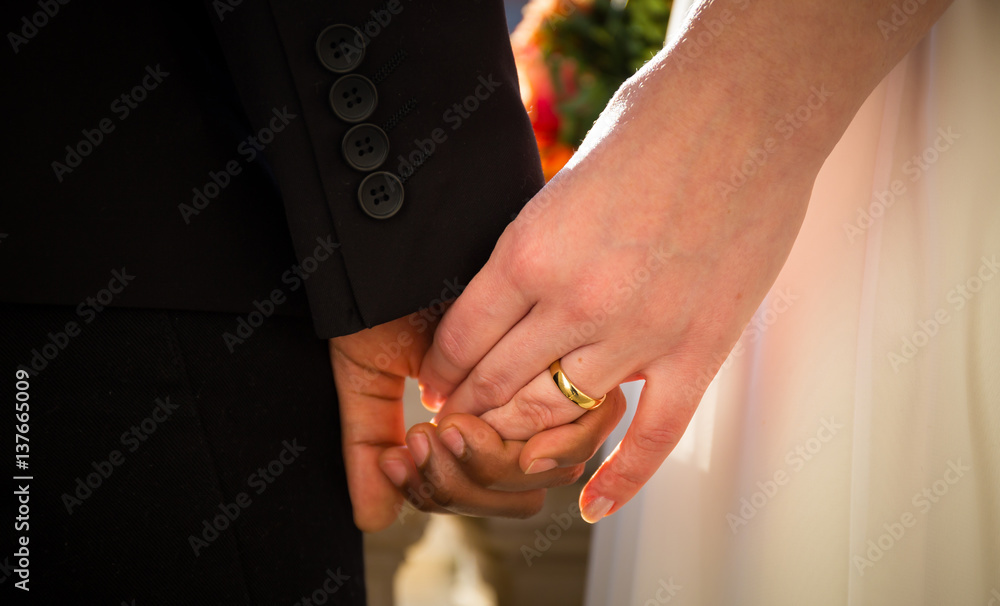 Wall mural bride and groom hands together