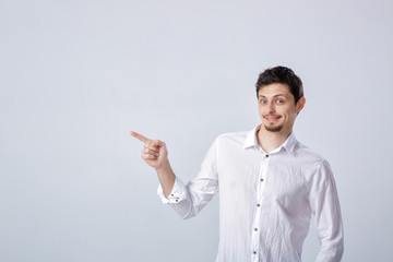 portrait of young man with dark hair in white shirt shows up on 