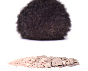 Cosmetic powder with makeup brush on white background