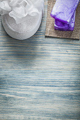 Purple handmade soap white bath sponge on wooden board spa treat