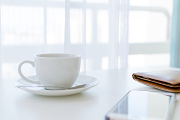 Coffee time in the morning, coffee cup with smartphone and wallets.