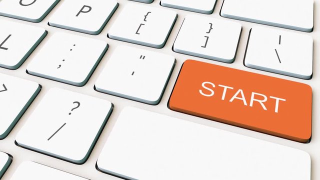 Dolly shot of white computer keyboard and orange start key. Conceptual 4K clip
