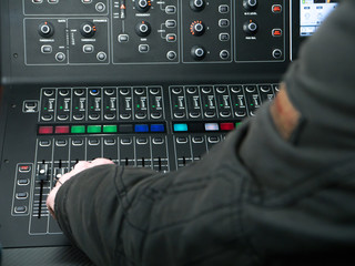 Man working on a mixing console in a recording studio