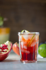 Fresh pomegranate drink - lemonade or cocktail with lime and ice