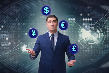 Businessman juggling between various currencies