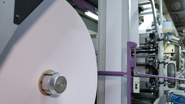 Big paper roll in an Envelope printing factory on the conveyor belt