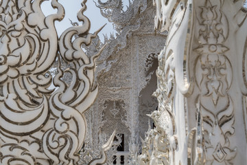 Sculpture detail and decoration in all-white contemporary buddhist temple Wat Rong Khun in Chiang Rai, Thailand