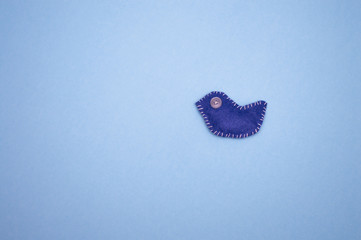 felted blue bird on a blue background
