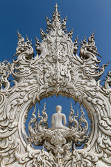 Fototapeta na wymiar Sculpture detail with white Buddha in all-white buddhist temple Wat Rong Khun in Chiang Rai, Thailand, symbol of creativity, serenity and peace