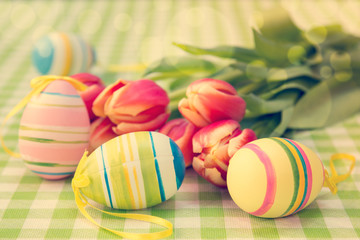 Fototapeta na wymiar Easter eggs and bunch of tulips