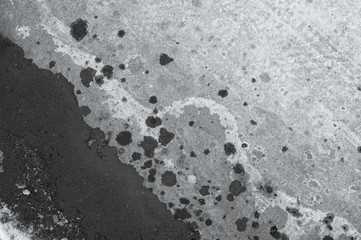 Surface of conrcete with many dark stains as abstract background
