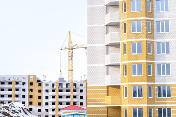 beautiful building and a successful business build tall buildings for residents. standing next to a construction crane.