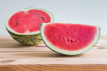 Watermelon on wooden table over grunge background