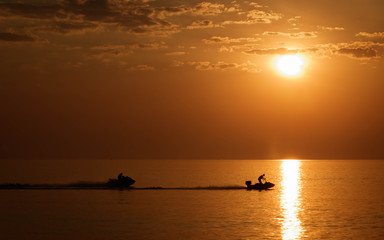 Silhouette jet ski in the sea landscape background